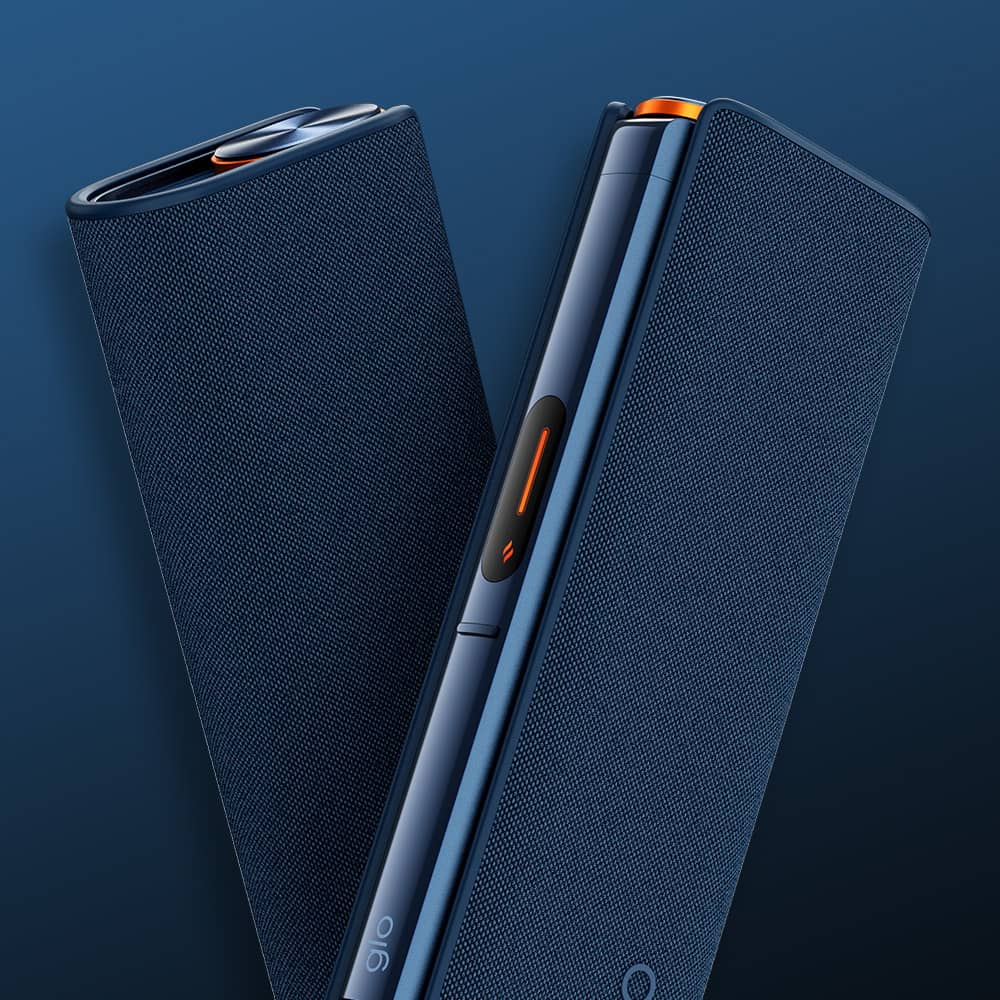 Two dark blue, rectangular electronic devices with textured surfaces are shown standing next to each other against a blue background. One device displays a small orange button and a glowing symbol on its side.