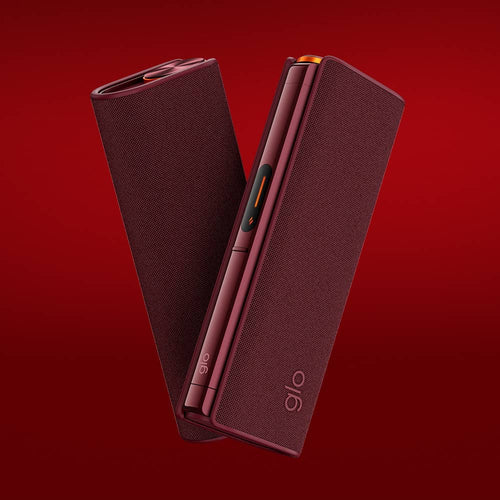 Two sleek, maroon-colored electronic devices with glo branding are shown against a solid red background, standing upright and slightly angled toward each other.