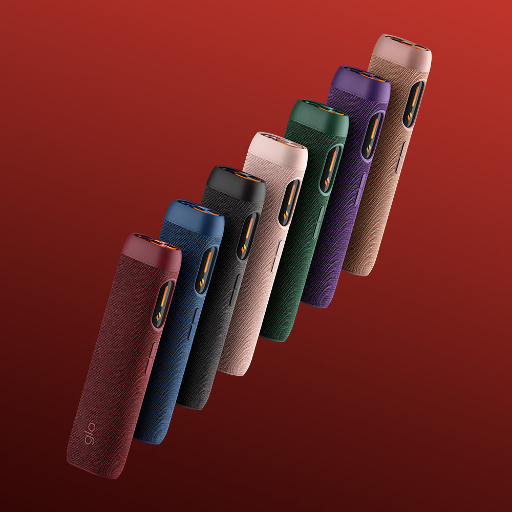 Seven sleek glo™ HILO Sleeve covers in red, blue, black, beige, green, and purple are lined up diagonally on a red gradient background, each offering stylish protection for your device.