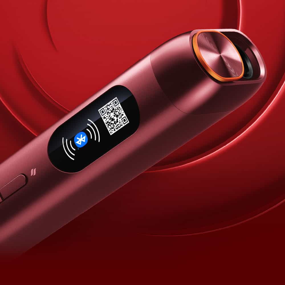 A close-up of a sleek, metallic red electronic device with a digital display showing a Bluetooth icon and a QR code, set against a red swirling background.